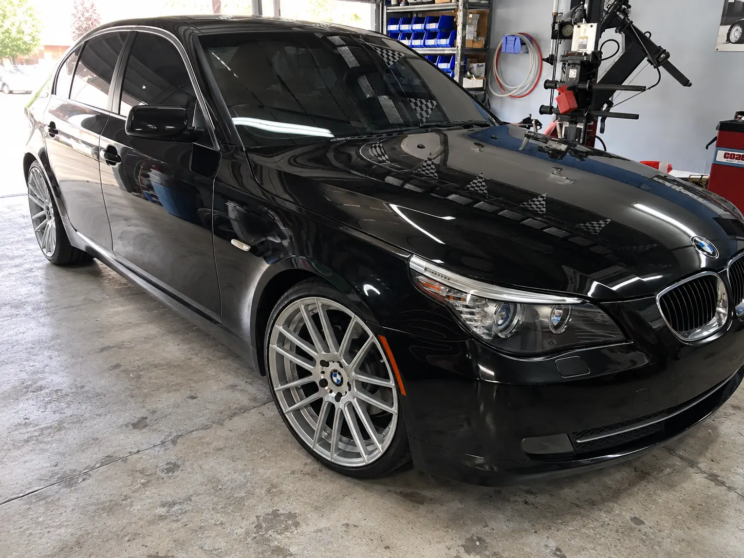 2009 BMW 5 Series in black on 20-inch hyper silver staggered wheels
