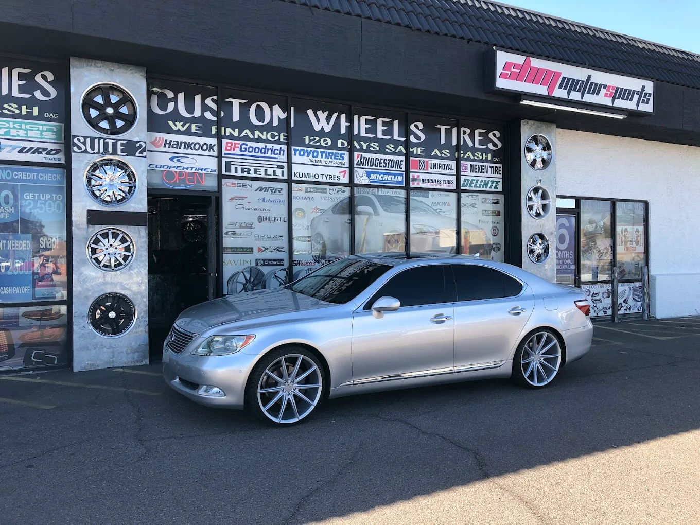 Silver Lexus on 22-inch staggered wheels with low-profile tires at SHM Motorsports