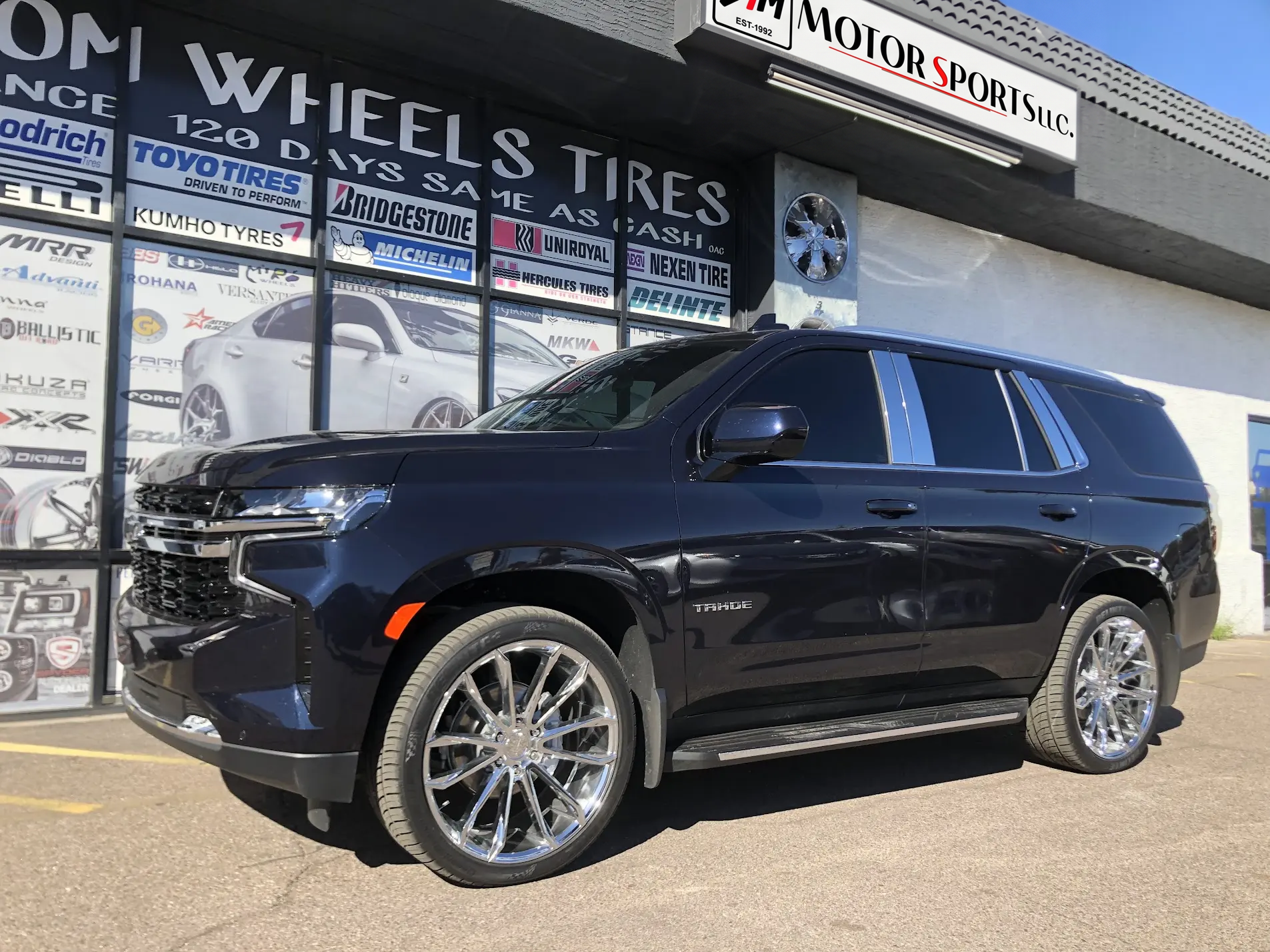 2021 Chevrolet Tahoe on 22-inch chrome wheels with 295/40R22 Dcenti Tires, window tint and chrome pillar trim