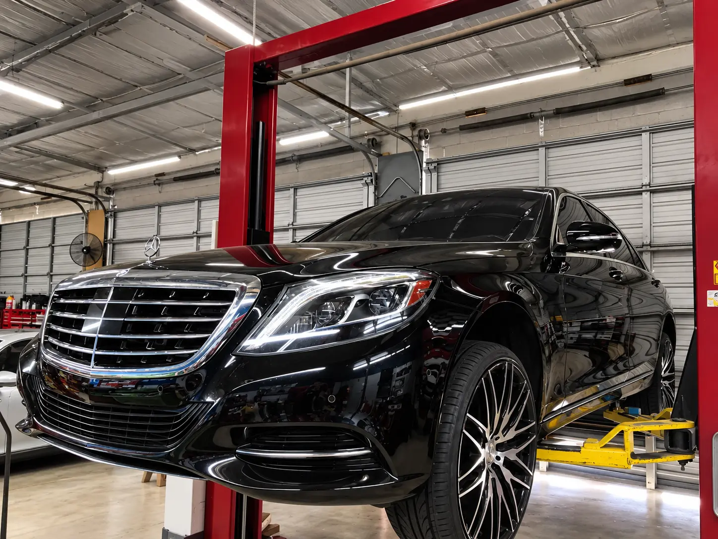 2015 Mercedes-Benz S500 on the lift with 20-inch staggered wheels and window tint