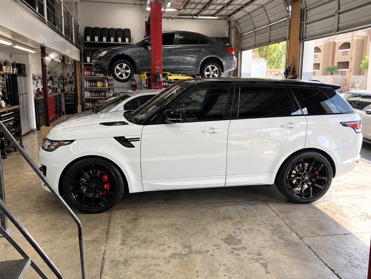 2017 Land Rover Range Rover Sport in white after window tint and a full brake service at SHM Motorsports