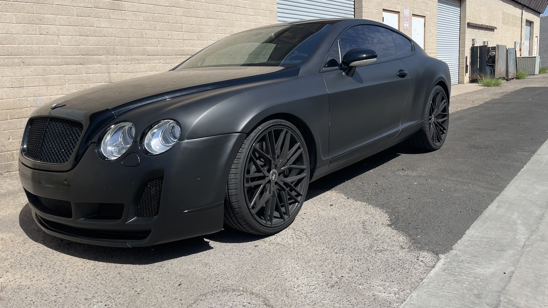 2011 Bentley Continental GT wrapped in 3M 2080-M12 matte black with gloss black hood and roof on 22-inch staggered wheels