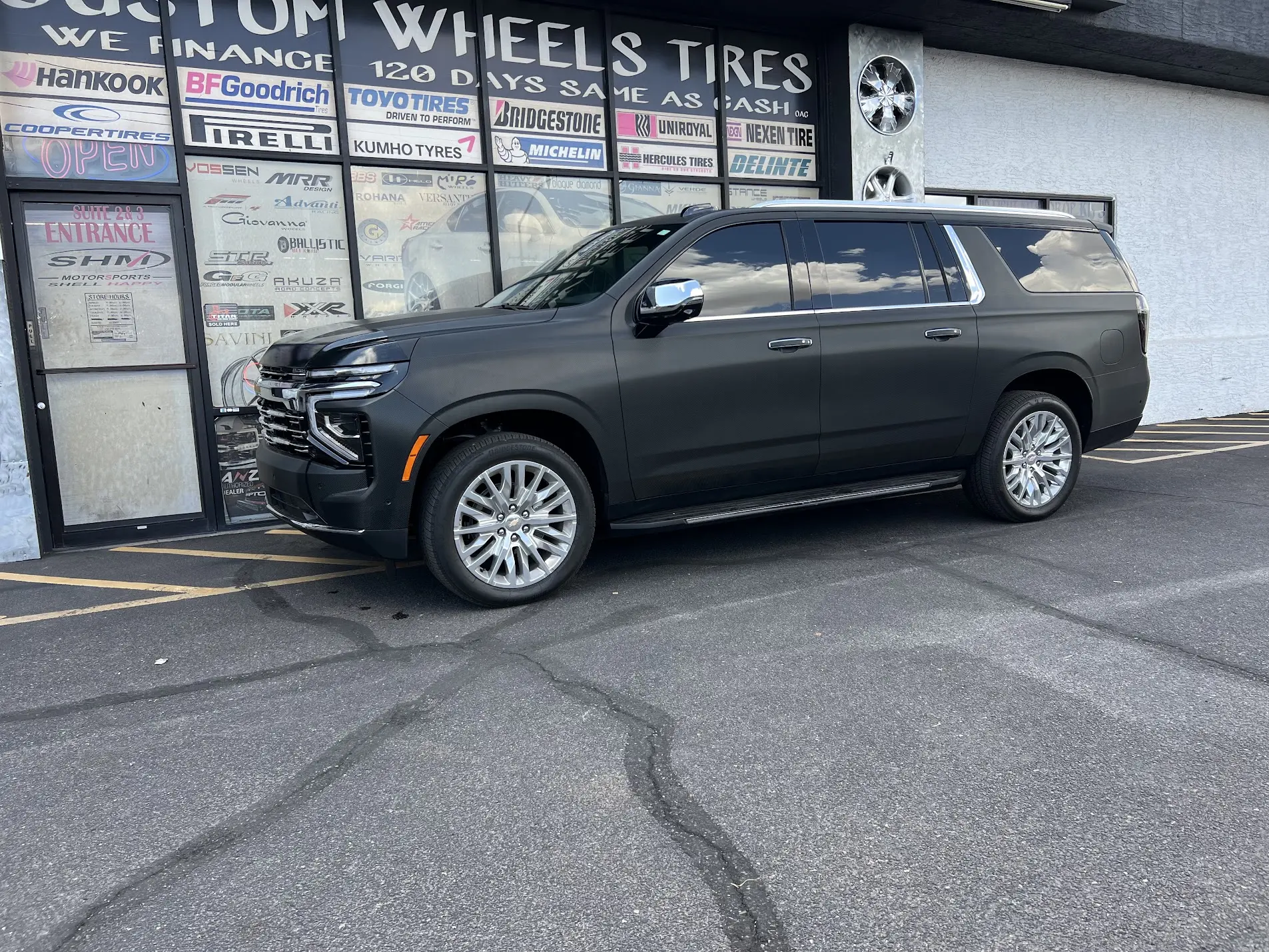 2025 Chevrolet Suburban fully wrapped in 3M 2080-CF12 Carbon Fiber Black vinyl with 5% ceramic window tint and partial front PPF