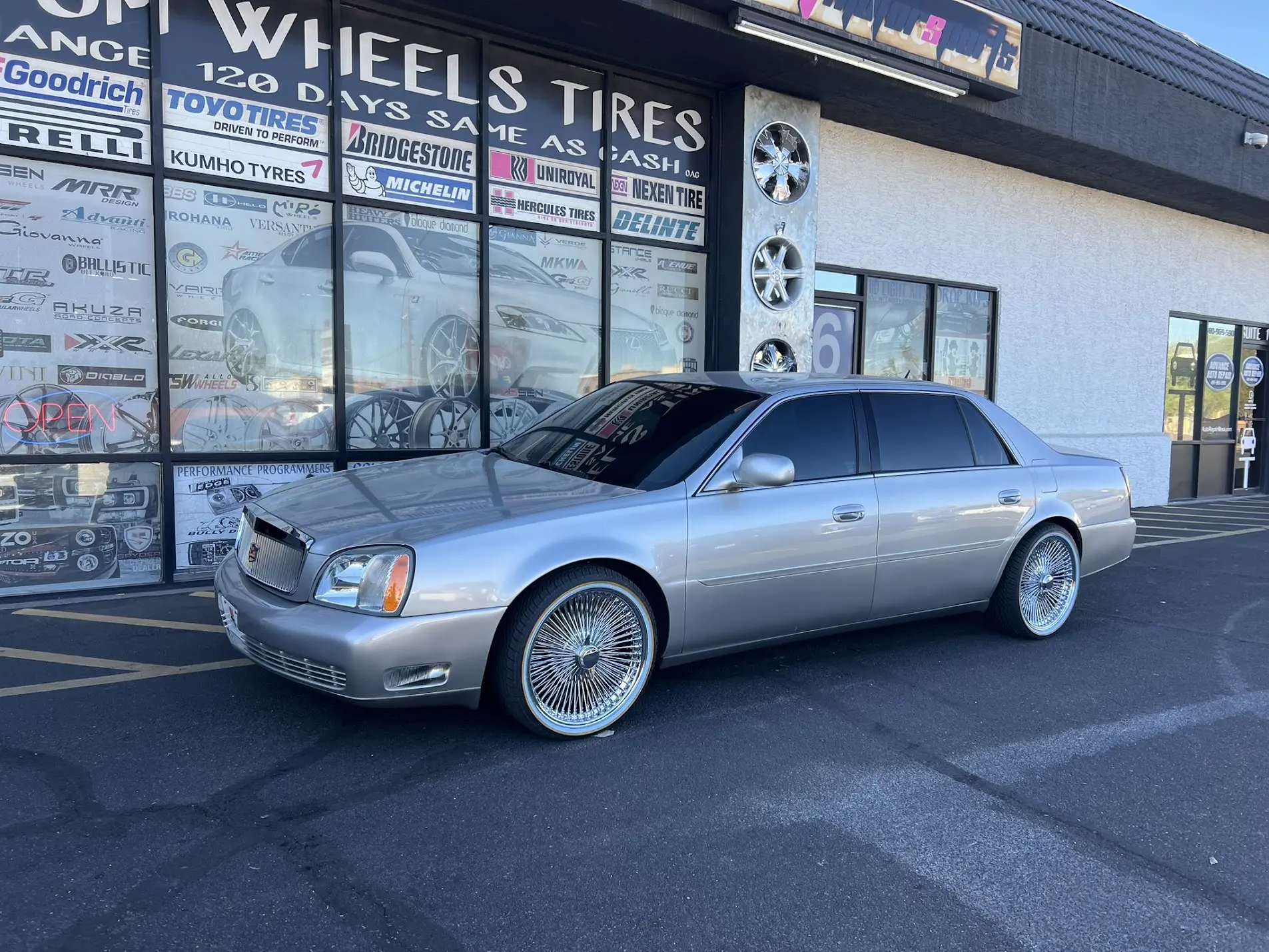 2005 Cadillac DeVille on 20-inch 100-spoke wire wheels with 245/45R20 Vogue white and yellow stripe tires