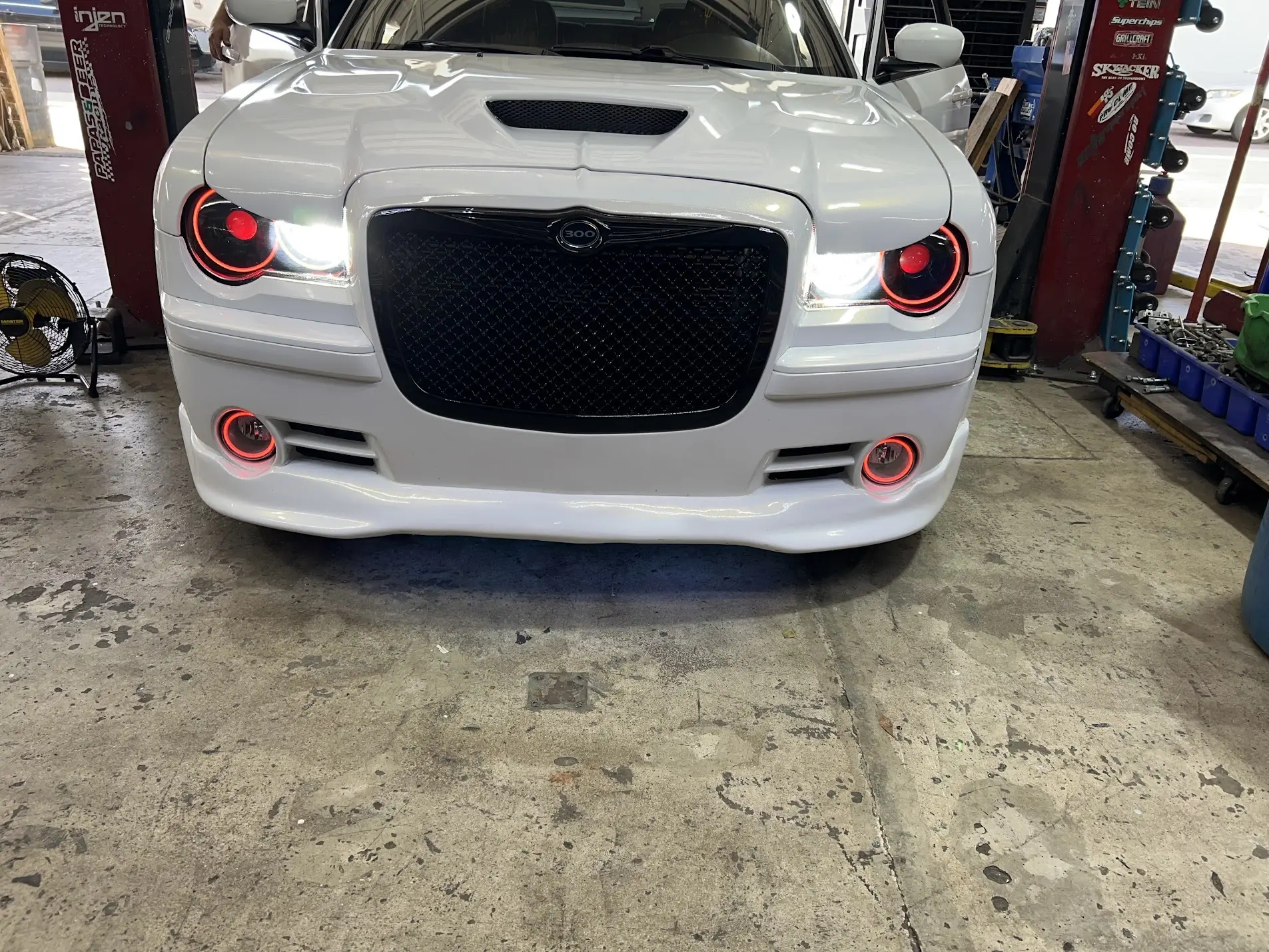 Chrysler 300 with custom halo headlights, grille, bumper and fog lights installed at SHM Motorsports