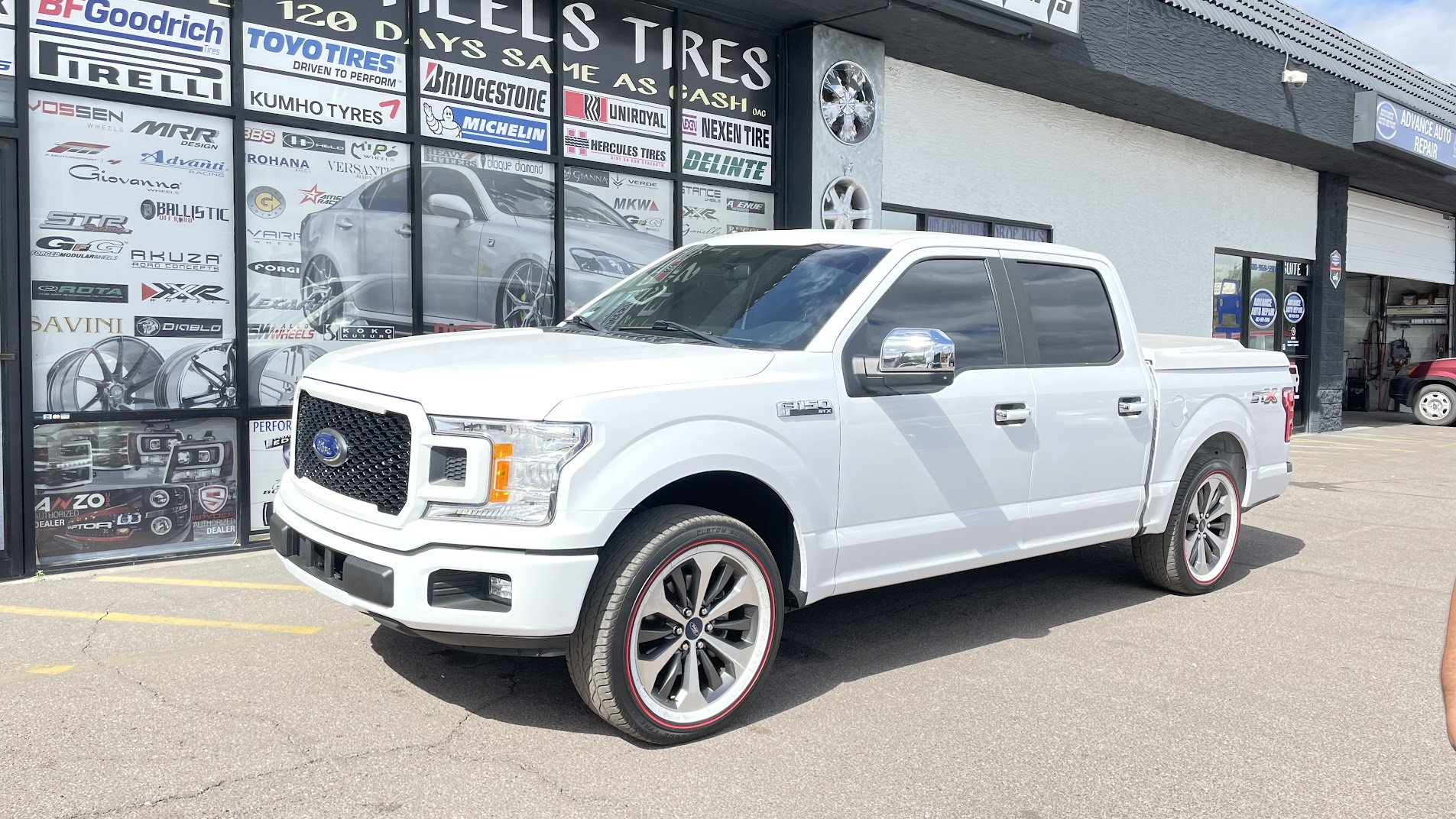 2024 Ford F-150 on 20-inch Vogue whitewall tires with red stripe at SHM Motorsports