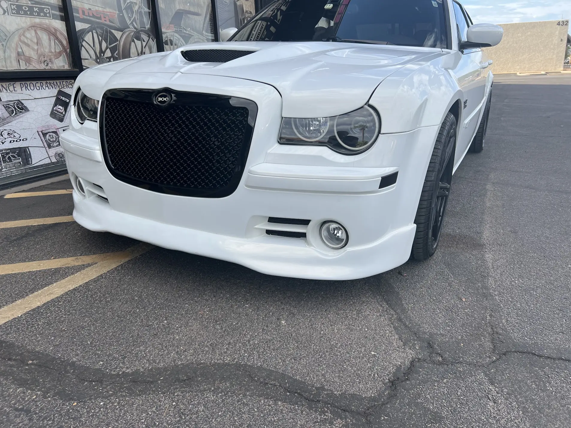 2008 Chrysler 300C in white pearl 3M wrap with custom front lower bumper and halo headlights