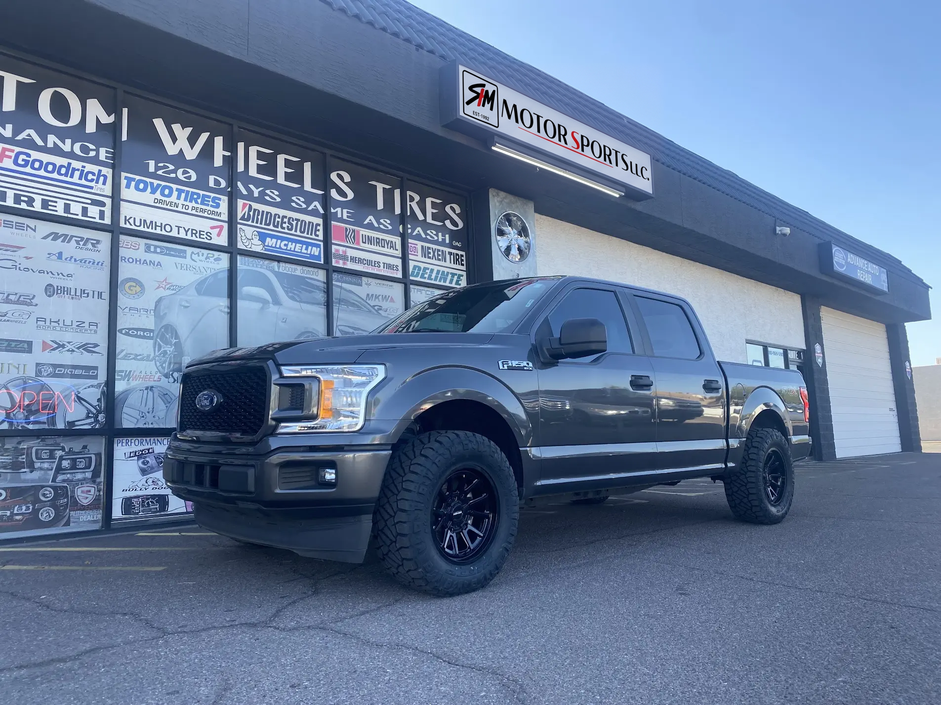 2016 Ford F-150 crew cab on 20x9.5 KMC wheels with 35x12.50R20 Nitto Ridge Grappler tires and a 1.5-inch front leveling kit