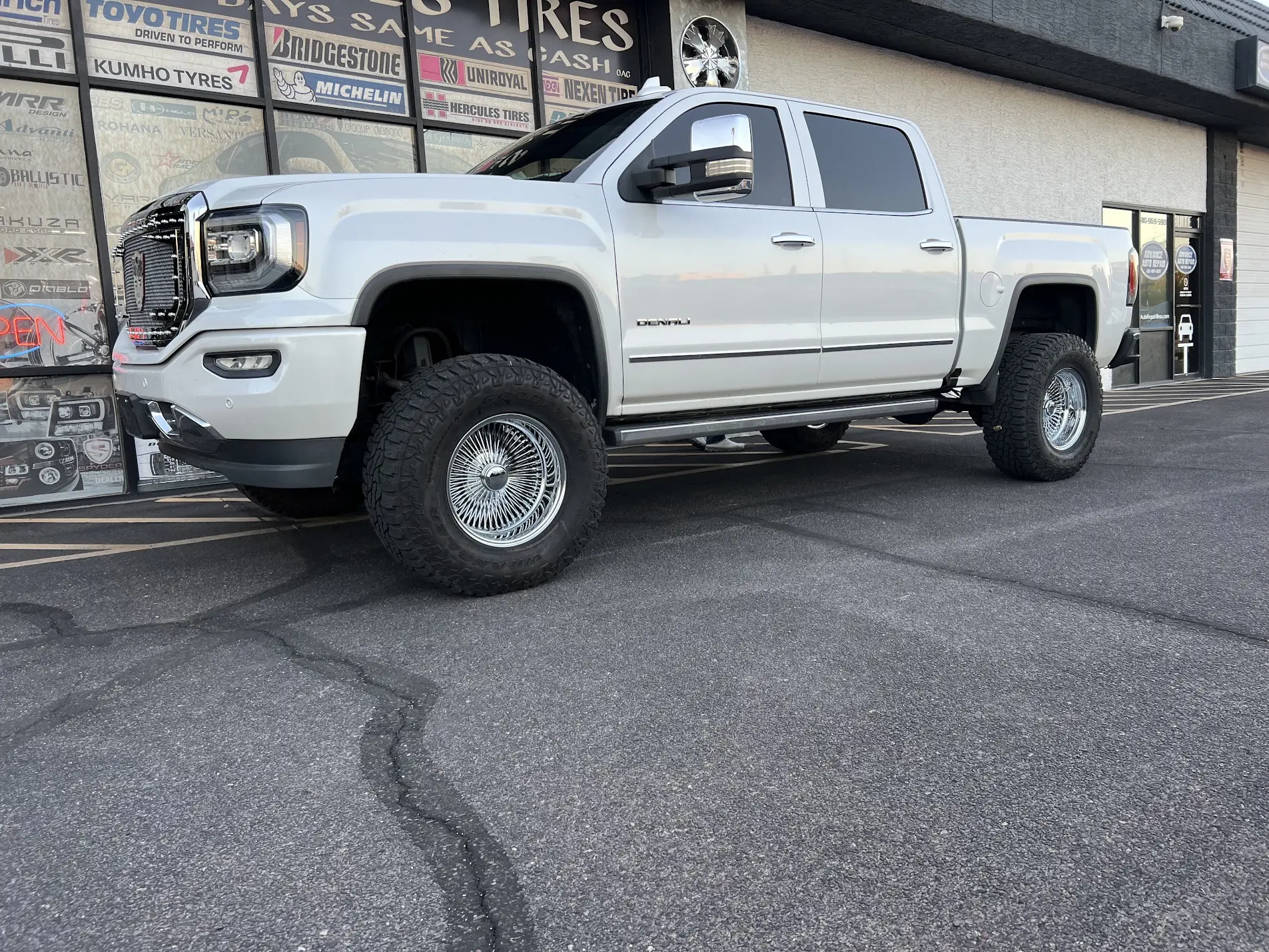 Lifted 2016 GMC 4x4 truck on 17x9 Hunter-spoke knockoff wire wheels